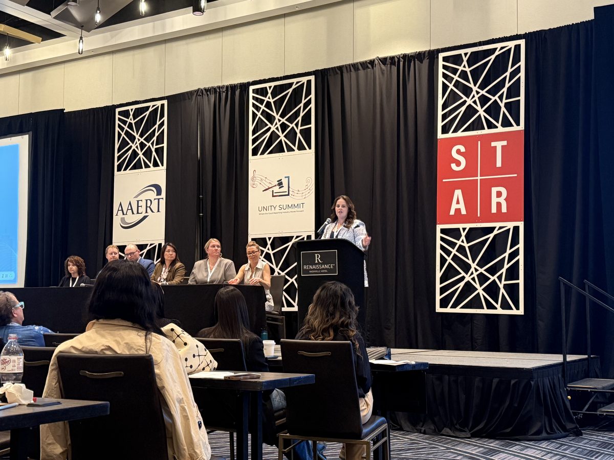Panel session at the AAERT Unity Summit, Nashville — speaker at the podium with AAERT, Unity Summit, and STAR banners on stage